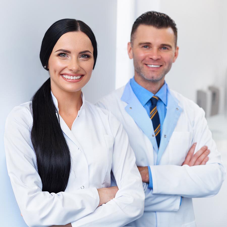 Dentist Team at Dental Clinic. Two Smiling Doctors at their Workplace